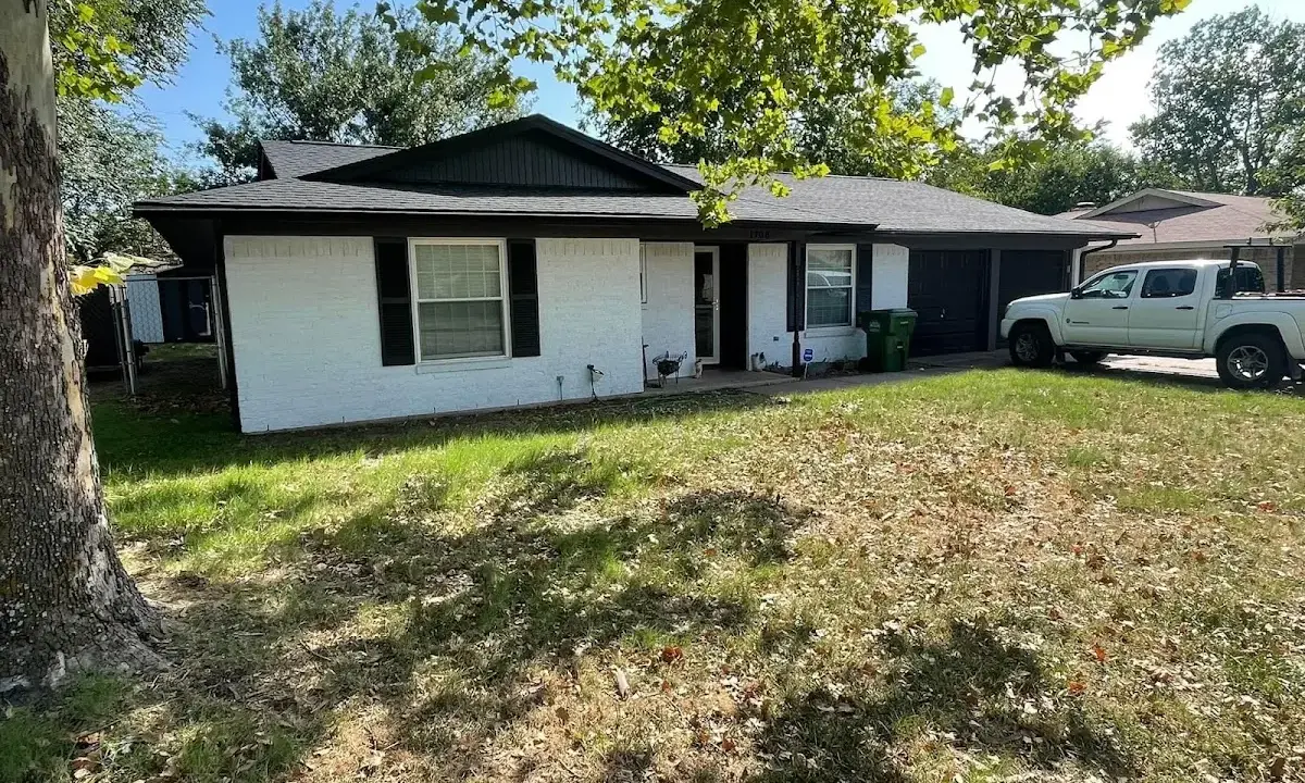 Professional roofing crew working on a residential roof in Webster